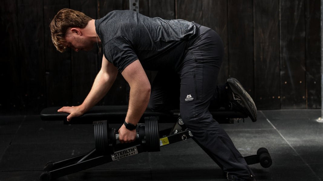 Samuel, the author doing supported rows using Stealth Core Edition adjustable dumbbell