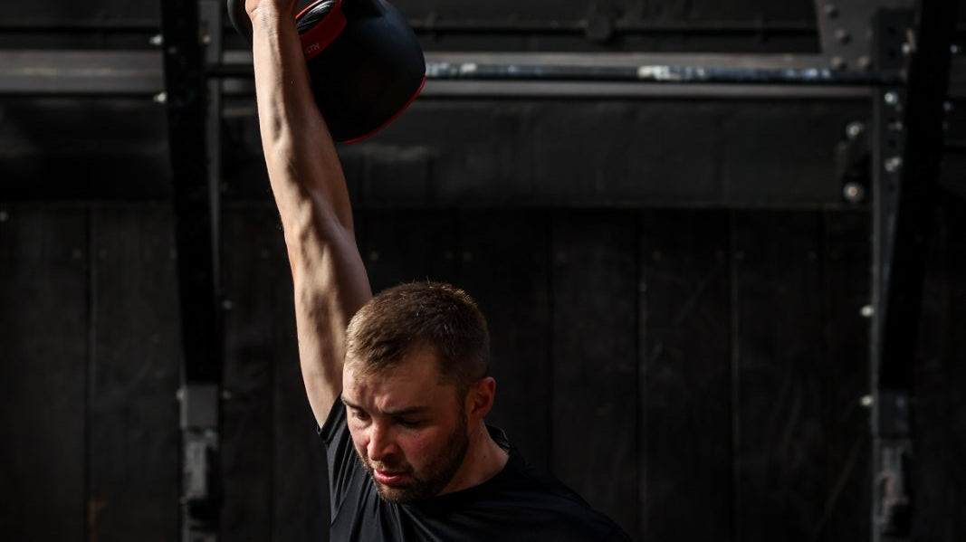 Assassin Goods Founder Mike executing a kettlebell clean and press