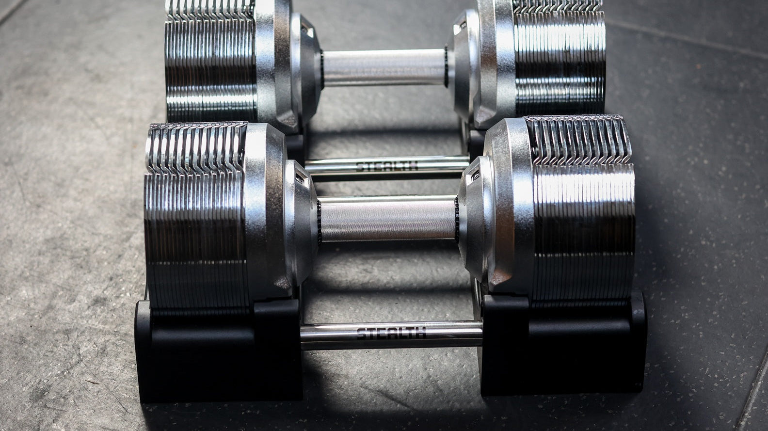 Stealth Chrome Edition adjustable dumbbells in their base