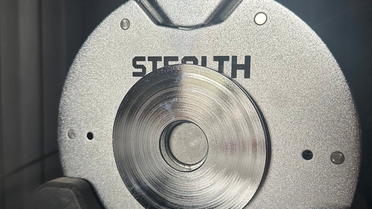 Magnetic micro add-on plates attached to a Stealth Adjustable Dumbbell