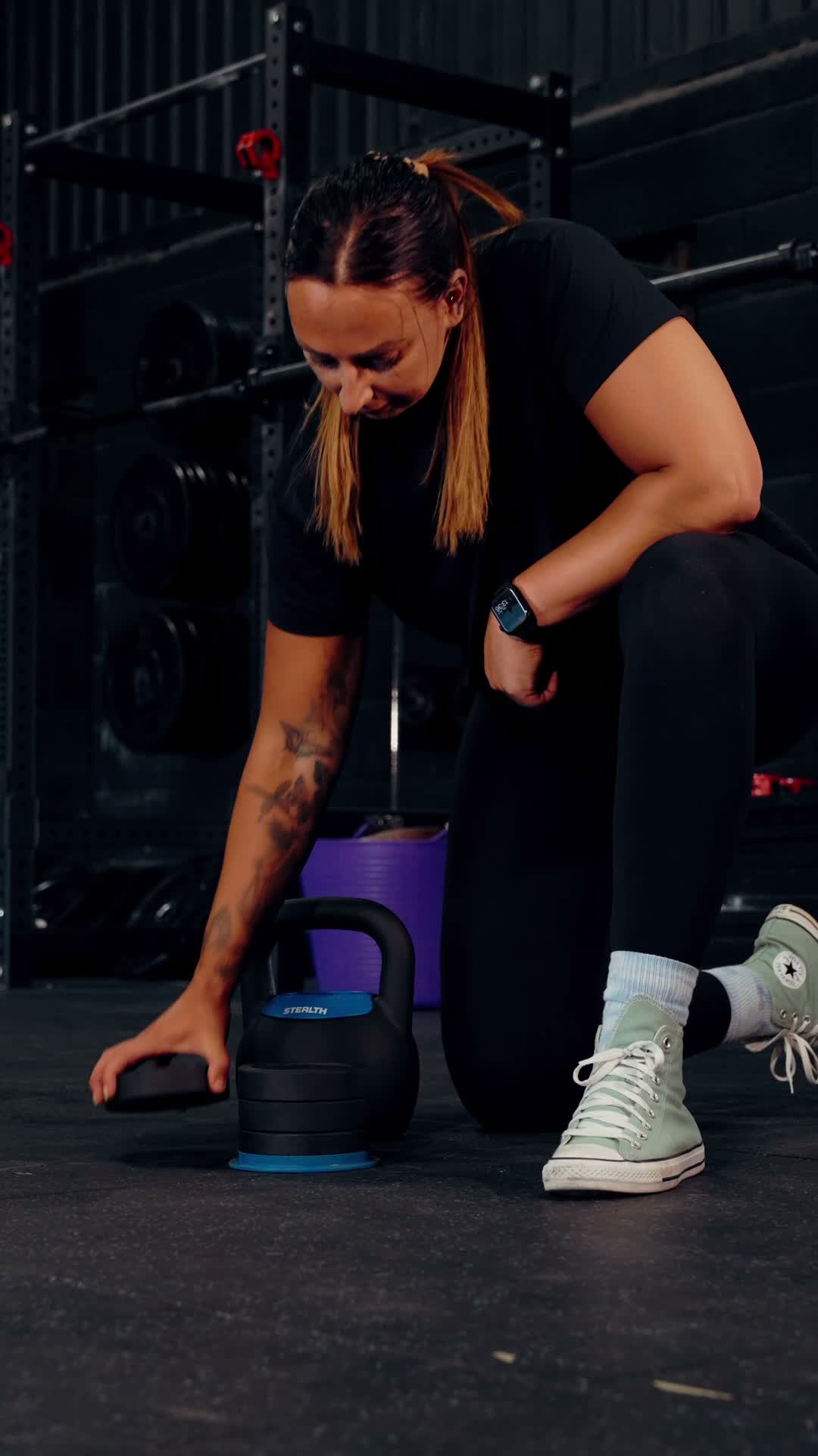 Kettlebell broken down into its weight plates on the gym floor